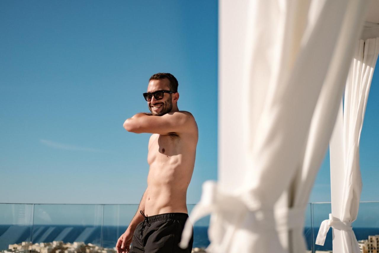 Hyatt Regency Malta Hotel Saint Julian's Exterior photo A man wearing a pair of board shorts